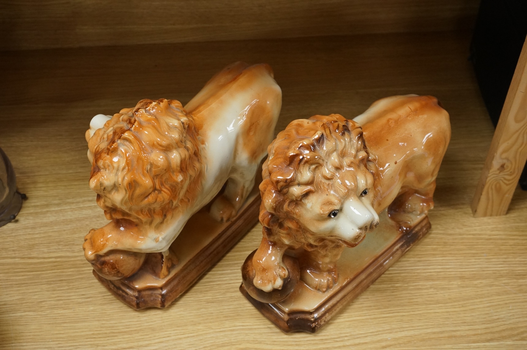 A pair of Staffordshire pottery lions, c.1900, 34cm